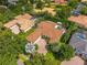 A beautiful home with a brick driveway and private pool is surrounded by lush landscaping in this aerial shot at 11015 Hawkshead Ct, Windermere, FL 34786