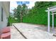 Paver patio and basketball hoop in backyard with privacy landscaping at 11015 Hawkshead Ct, Windermere, FL 34786