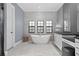 Elegant bathroom with freestanding tub, modern fixtures, and ample natural light at 11015 Hawkshead Ct, Windermere, FL 34786