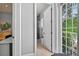 Hallway view of a gray-toned bathroom with a glass shower and white trim at 11015 Hawkshead Ct, Windermere, FL 34786