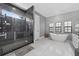 Modern bathroom featuring walk-in shower, freestanding tub, and sleek gray accents at 11015 Hawkshead Ct, Windermere, FL 34786