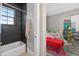 A modern bathroom featuring sleek tile and a view into an adjacent bedroom at 11015 Hawkshead Ct, Windermere, FL 34786