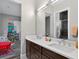 Bright bathroom featuring a double sink vanity with sleek faucets and modern finishes at 11015 Hawkshead Ct, Windermere, FL 34786