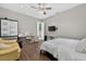 Light-filled bedroom featuring wood floors, a double bed, and a desk area at 11015 Hawkshead Ct, Windermere, FL 34786