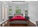 Bright bedroom showcasing a modern bed, bedside tables, and floor-to-ceiling windows at 11015 Hawkshead Ct, Windermere, FL 34786