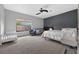 Serene bedroom featuring a dark accent wall, a cozy bed, and neutral carpet at 11015 Hawkshead Ct, Windermere, FL 34786