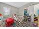 bedroom with a play table, bookshelves, and a large window for natural light at 11015 Hawkshead Ct, Windermere, FL 34786