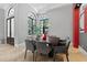 An elegant dining room featuring two oversized windows and pendant lighting at 11015 Hawkshead Ct, Windermere, FL 34786