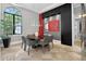 Modern dining room featuring black accent wall and large windows at 11015 Hawkshead Ct, Windermere, FL 34786