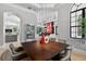 Elegant dining room with hardwood table and chairs, chandelier, and backyard views at 11015 Hawkshead Ct, Windermere, FL 34786