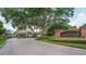 Gated brick entrance to the Lake Butler Sound community with lush landscaping and mature trees at 11015 Hawkshead Ct, Windermere, FL 34786