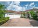 Well-maintained home featuring a brick driveway, lush landscaping and a two-car garage at 11015 Hawkshead Ct, Windermere, FL 34786
