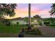 Exterior view of a charming home with a brick driveway and beautiful landscaping at sunset at 11015 Hawkshead Ct, Windermere, FL 34786