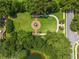Aerial view of a meticulously landscaped community garden with circular water feature and symmetrical design at 11015 Hawkshead Ct, Windermere, FL 34786