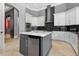 Bright kitchen featuring white cabinets, grey island, and modern stainless steel appliances at 11015 Hawkshead Ct, Windermere, FL 34786
