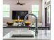 Modern kitchen features stainless steel fixtures, marble countertops and sleek cabinetry in a bright and airy space at 11015 Hawkshead Ct, Windermere, FL 34786