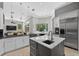 Open kitchen features an island, stainless appliances, and seamless connection to the breakfast area at 11015 Hawkshead Ct, Windermere, FL 34786