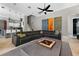 Inviting living room features a comfortable leather couch and seamless flow to the kitchen at 11015 Hawkshead Ct, Windermere, FL 34786
