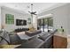 Open living room boasting sleek tile floors, modern furniture, and sliding glass doors leading to the backyard pool at 11015 Hawkshead Ct, Windermere, FL 34786