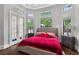 Bright main bedroom with large windows, hardwood floors, and stylish bedside tables at 11015 Hawkshead Ct, Windermere, FL 34786