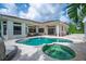 Wonderful backyard pool and spa with travertine deck, covered lanais, and room to relax and enjoy the outdoors at 11015 Hawkshead Ct, Windermere, FL 34786