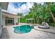 Beautiful backyard pool with travertine deck, outdoor lounge area, privacy landscaping, and room to relax and enjoy the outdoors at 11015 Hawkshead Ct, Windermere, FL 34786