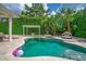 Lovely backyard pool with travertine deck, privacy landscaping, pergola, and room to relax and enjoy the outdoors at 11015 Hawkshead Ct, Windermere, FL 34786