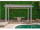 Tranquil poolside cabana with lush greenery, providing a serene and private retreat at 11015 Hawkshead Ct, Windermere, FL 34786