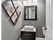 Modern powder room featuring a vessel sink, decorative art, and updated fixtures at 11015 Hawkshead Ct, Windermere, FL 34786