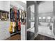 Spacious walk-in closet with custom shelving and a view into the luxurious bathroom at 11015 Hawkshead Ct, Windermere, FL 34786