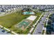 Aerial view showcases community amenities like a pool, basketball court, and volleyball court at 11408 Satire St, Orlando, FL 32832