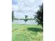 Tranquil backyard view overlooking a serene lake, offering a peaceful and private setting at 11408 Satire St, Orlando, FL 32832