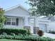 Charming home exterior with a well-maintained front yard and a covered porch at 11408 Satire St, Orlando, FL 32832