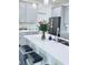 Modern kitchen showcasing a stylish island with barstools and gray cabinetry at 11408 Satire St, Orlando, FL 32832