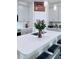 Open kitchen featuring a quartz countertop island with a stainless steel sink and gray cabinetry at 11408 Satire St, Orlando, FL 32832