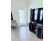 Bright living room with a modern TV stand, comfortable chair, and plenty of natural light at 11408 Satire St, Orlando, FL 32832
