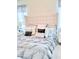 Comfortable main bedroom featuring a tufted headboard, plush bedding, and soft, neutral tones at 11408 Satire St, Orlando, FL 32832