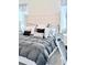 Serene main bedroom featuring a tufted headboard, plush bedding, and soft, neutral tones at 11408 Satire St, Orlando, FL 32832