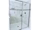 Modern walk-in shower with rainfall showerhead and custom tile surround at 11408 Satire St, Orlando, FL 32832