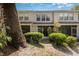 Townhouse backyard with a cozy screened-in patio, lush green bushes, and beautiful foliage at 1178 Vineland Pl, Lake Mary, FL 32746