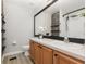 Bathroom with an expansive mirror, a stone-accented wall, and modern fixtures at 1178 Vineland Pl, Lake Mary, FL 32746