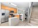 Efficient kitchen layout adjacent to stairs, featuring stainless steel appliances at 1178 Vineland Pl, Lake Mary, FL 32746