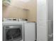 Bright laundry room featuring modern washer and dryer, plus convenient shelving for organized storage at 1178 Vineland Pl, Lake Mary, FL 32746