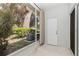 Screened patio with outdoor access, offering a view of green bushes and beautiful foliage at 1178 Vineland Pl, Lake Mary, FL 32746
