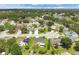 Aerial view of a neighborhood with well-maintained lawns, homes, and mature trees at 1406 Sean Ct, St Cloud, FL 34772