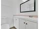 Bathroom vanity features a black framed mirror, a white sink, and white tiled countertops at 1406 Sean Ct, St Cloud, FL 34772