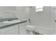 This bathroom features a shower-tub combo, and a vanity with tiled countertops at 1406 Sean Ct, St Cloud, FL 34772