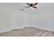 Spacious bedroom with ceiling fan, fresh floors, and three closets at 1406 Sean Ct, St Cloud, FL 34772