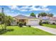Charming single-story home featuring a well-manicured front yard and driveway at 1406 Sean Ct, St Cloud, FL 34772