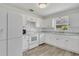 Bright kitchen with white appliances, ample cabinet space, and natural light at 1406 Sean Ct, St Cloud, FL 34772
